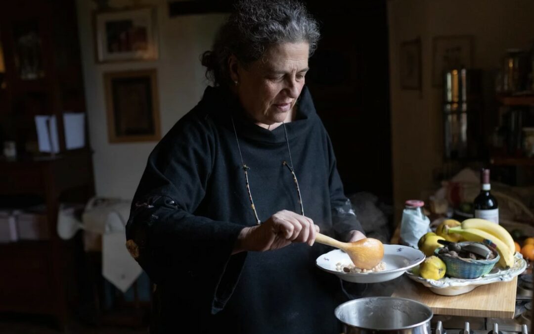 a woman serving food with a wooden spoon