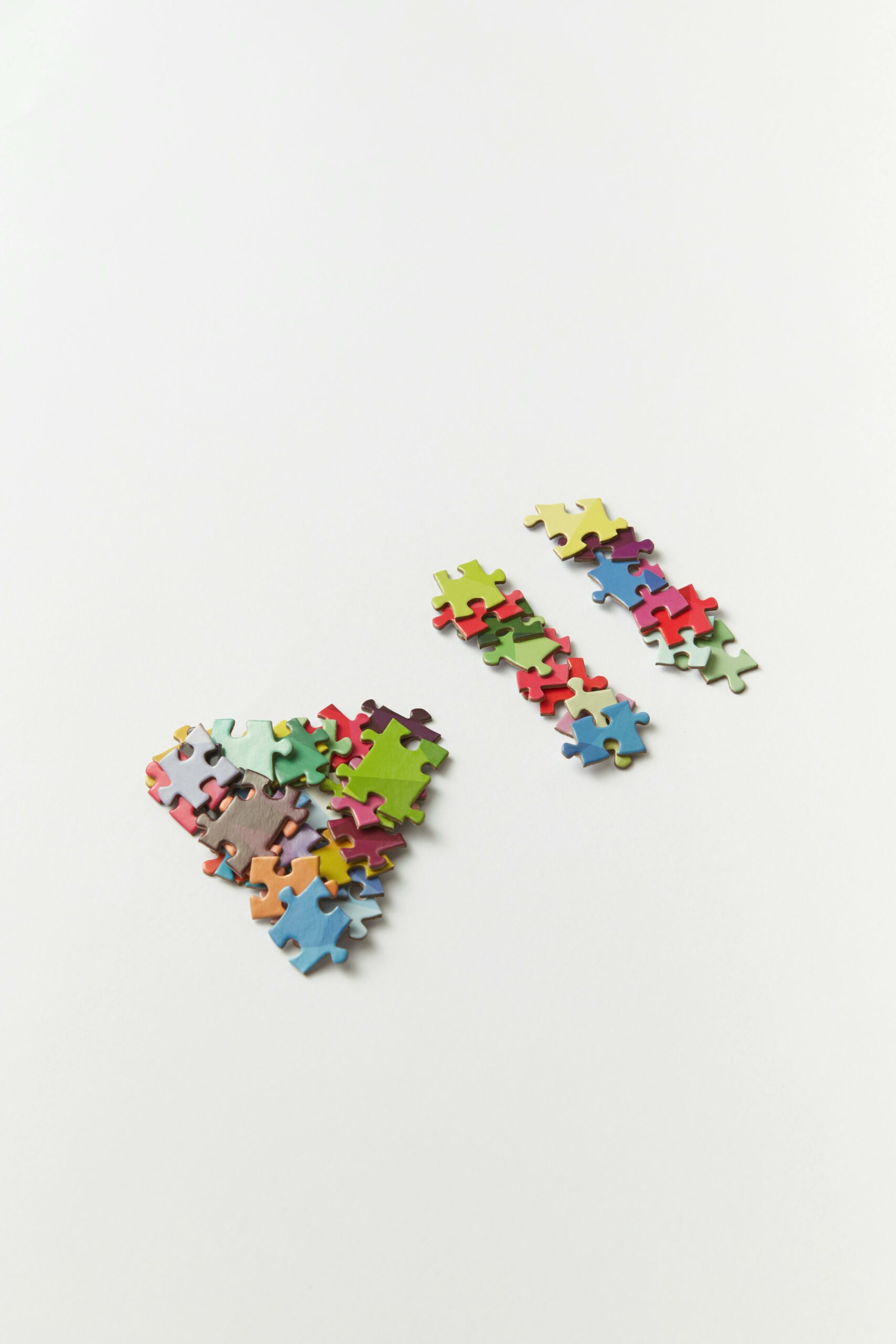 pexels-ds-stories-9227252 puzzle pieces arranged to make a triangle play symbol and a two-line pause symbol